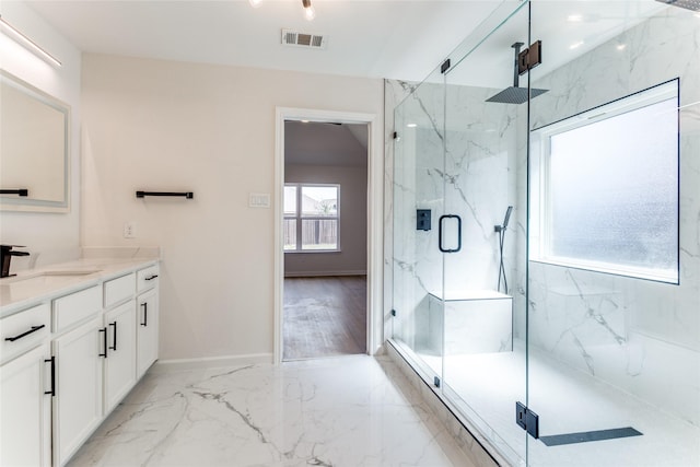 bathroom with walk in shower and vanity