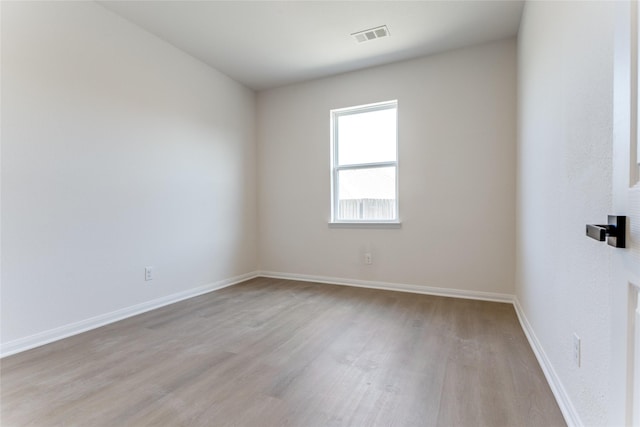 unfurnished room with light hardwood / wood-style flooring