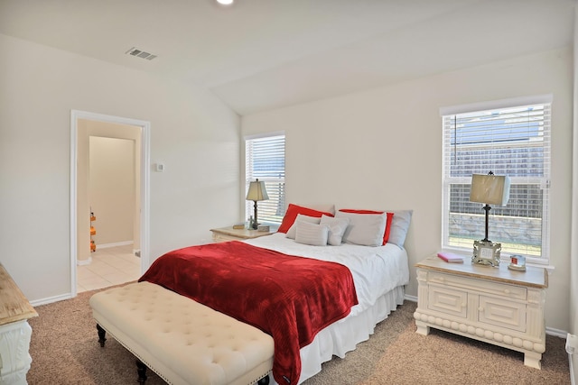 carpeted bedroom with vaulted ceiling