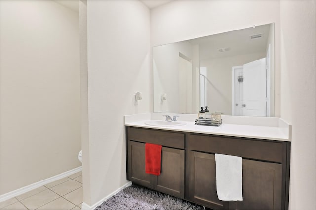 bathroom with vanity, tile patterned floors, and toilet