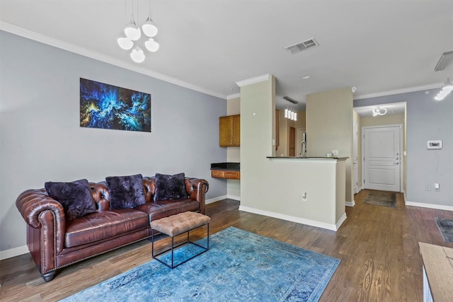 living room with a chandelier, dark hardwood / wood-style floors, and ornamental molding