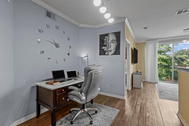 home office featuring hardwood / wood-style flooring and ornamental molding