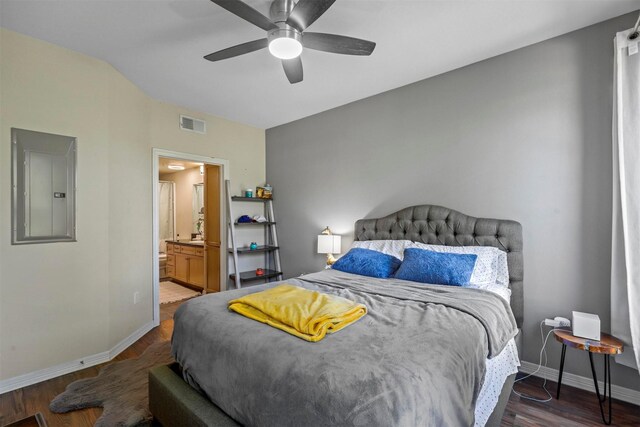 bedroom with electric panel, ceiling fan, ensuite bath, and dark wood-type flooring