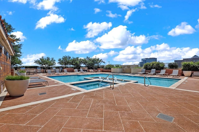 view of pool with a patio and a hot tub