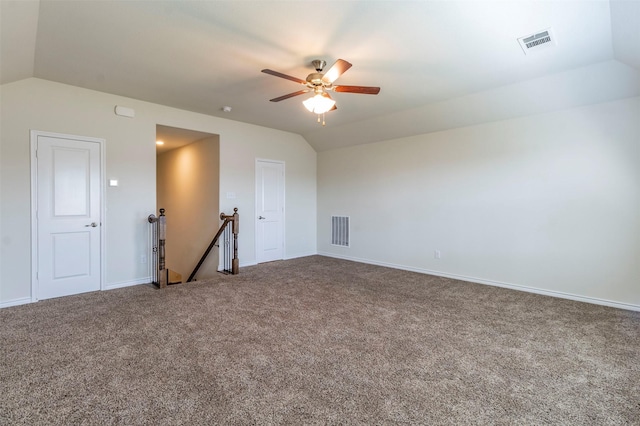 carpeted empty room featuring ceiling fan and lofted ceiling