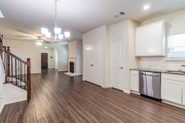 kitchen with dishwasher, hanging light fixtures, tasteful backsplash, white cabinets, and ceiling fan with notable chandelier