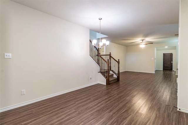 interior space featuring dark hardwood / wood-style floors and ceiling fan with notable chandelier