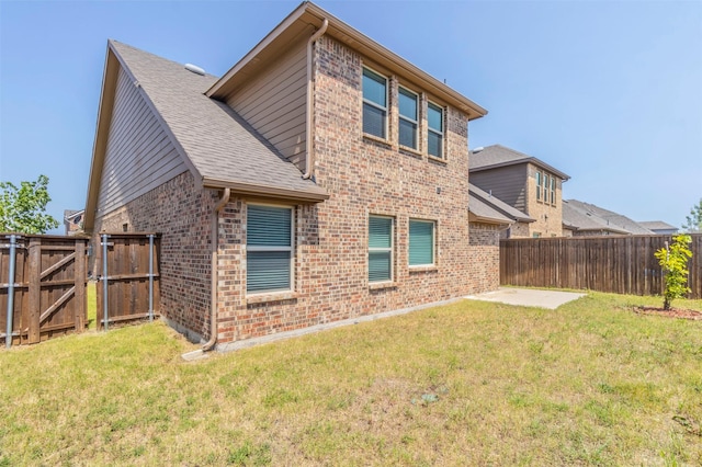 back of house featuring a yard and a patio