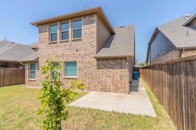 back of house featuring a yard and a patio