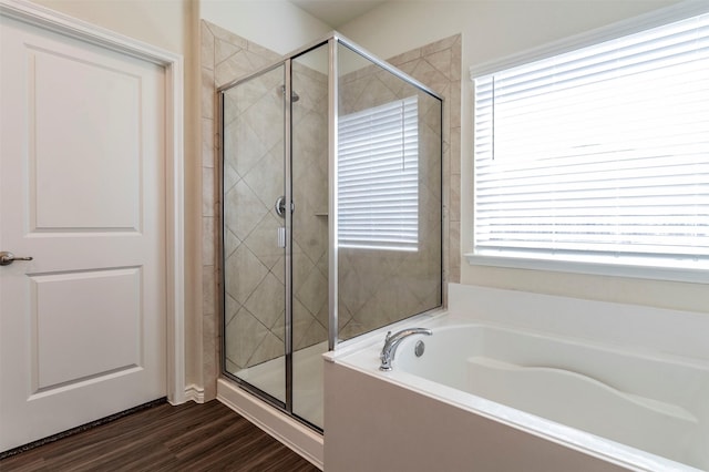 bathroom featuring hardwood / wood-style floors and separate shower and tub