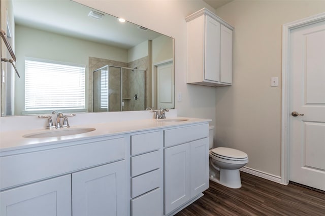 bathroom with vanity, toilet, an enclosed shower, and wood-type flooring