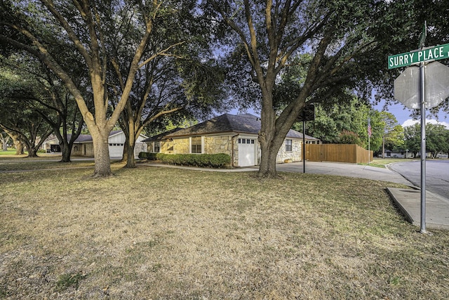 ranch-style home with a garage and a front yard