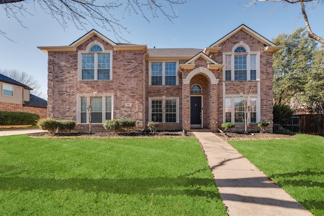 view of property featuring a front lawn