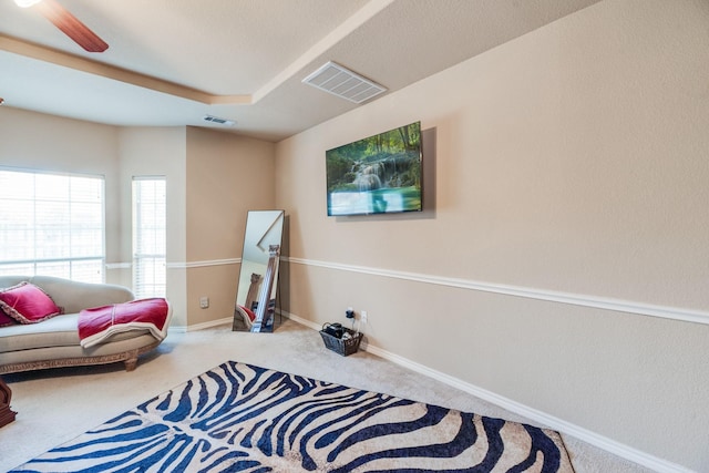 sitting room with carpet and ceiling fan