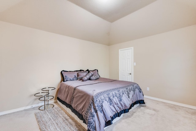 carpeted bedroom with vaulted ceiling