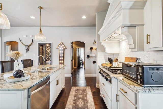 kitchen with white cabinets, appliances with stainless steel finishes, and sink