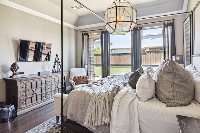 bedroom featuring dark hardwood / wood-style floors, an inviting chandelier, lofted ceiling, and multiple windows