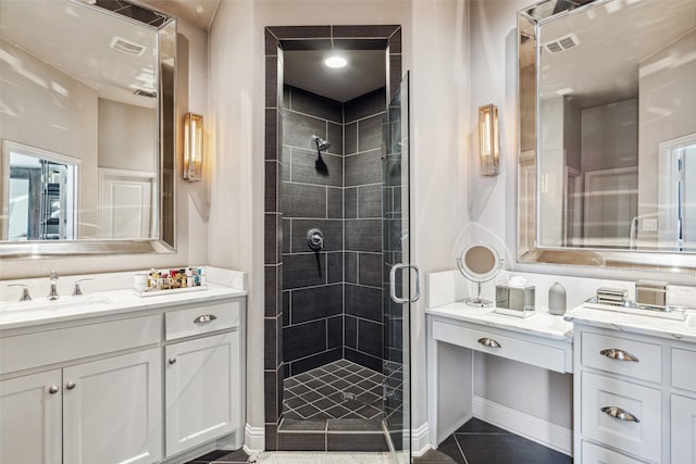 bathroom featuring a shower with door, vanity, and tile patterned flooring