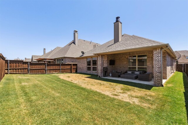 rear view of house with outdoor lounge area, a patio area, and a lawn