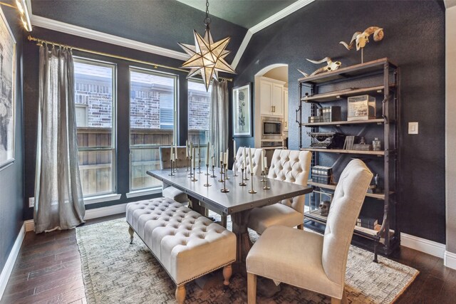 dining area featuring dark hardwood / wood-style flooring and ornamental molding