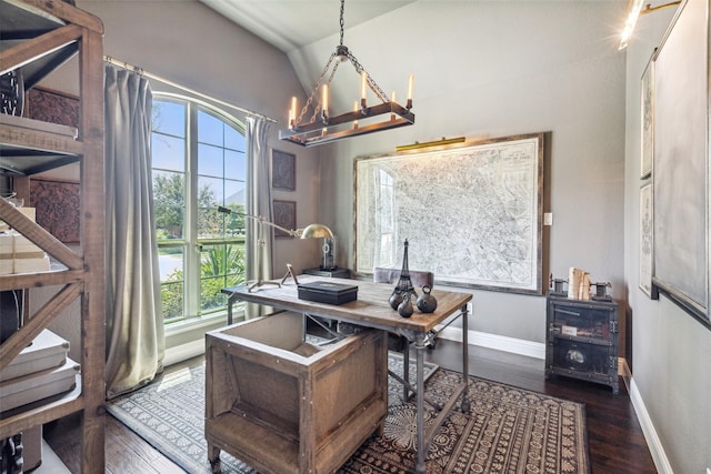 office space with dark hardwood / wood-style floors, lofted ceiling, and a chandelier