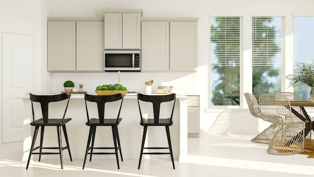 kitchen featuring tasteful backsplash and gray cabinets