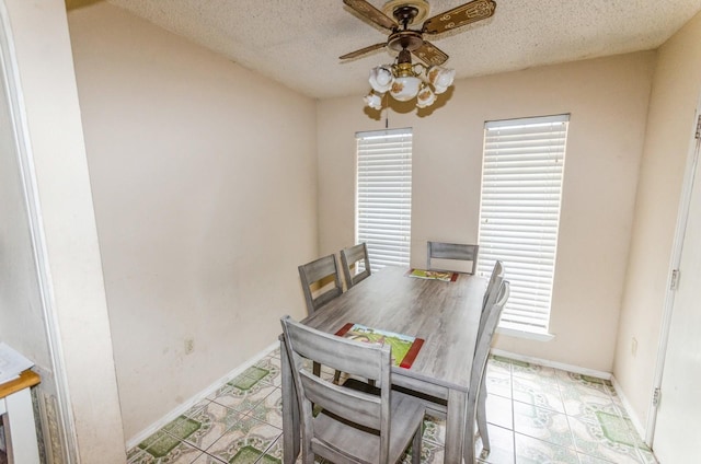 dining room with a textured ceiling and ceiling fan