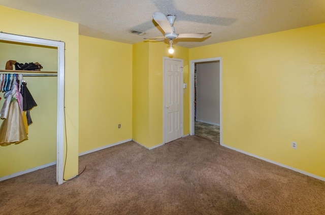 unfurnished bedroom with ceiling fan, a closet, carpet, and a textured ceiling