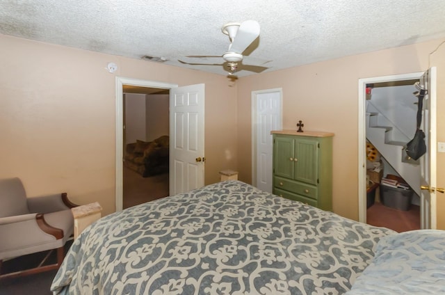 bedroom featuring ceiling fan, a textured ceiling, and a closet