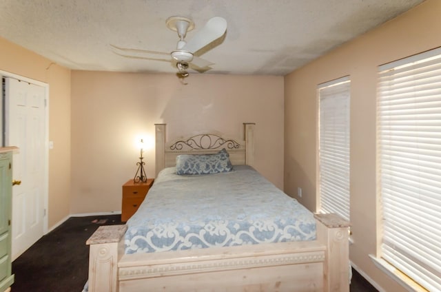 carpeted bedroom with a textured ceiling and ceiling fan