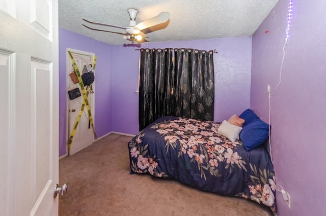 carpeted bedroom featuring ceiling fan and a textured ceiling