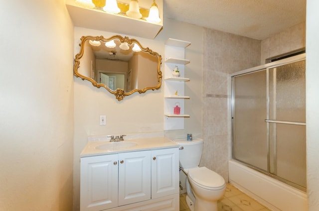 full bathroom with vanity, toilet, and combined bath / shower with glass door