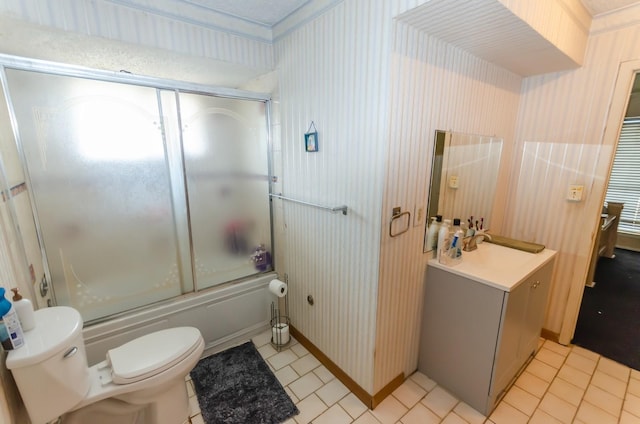 full bathroom featuring tile patterned flooring, sink, combined bath / shower with glass door, and toilet