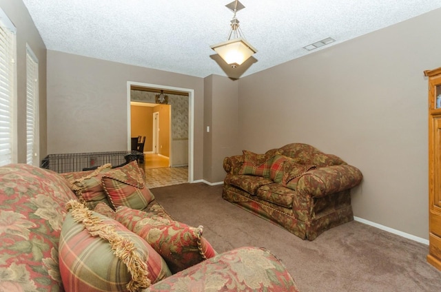 carpeted living room featuring a textured ceiling