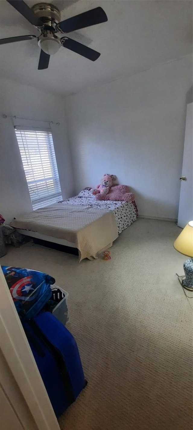 bedroom featuring ceiling fan and carpet floors