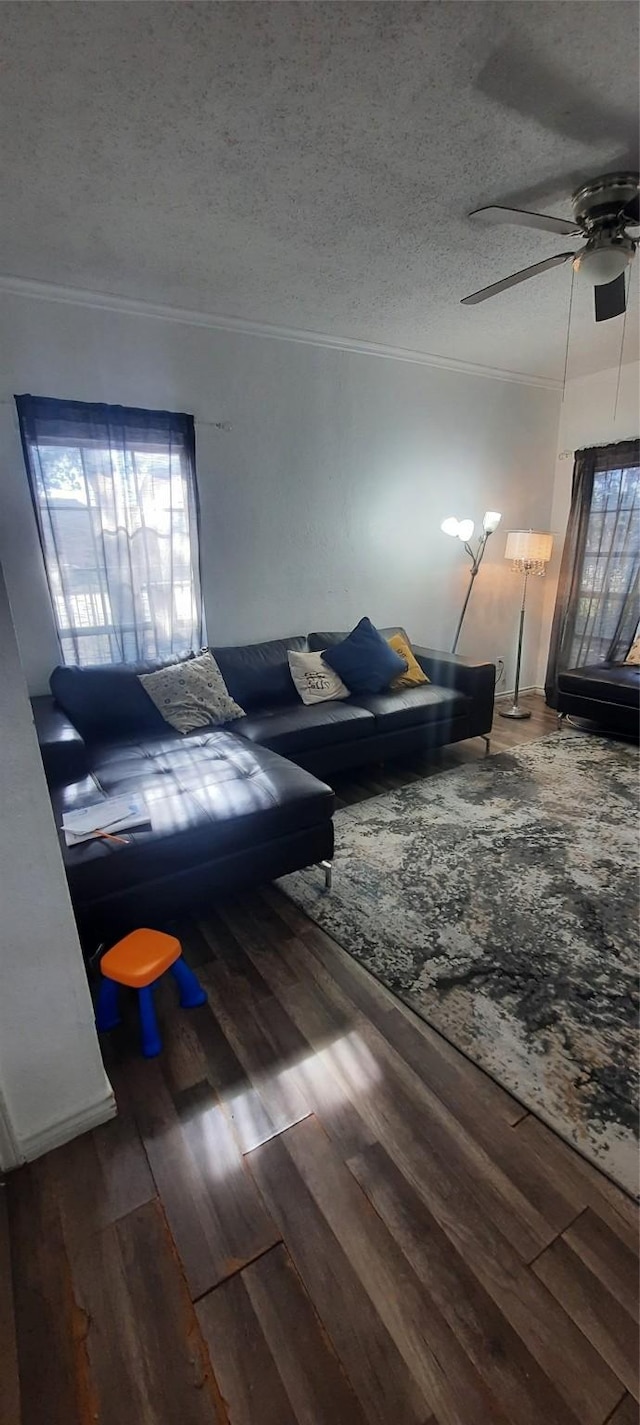 living area with crown molding and wood finished floors