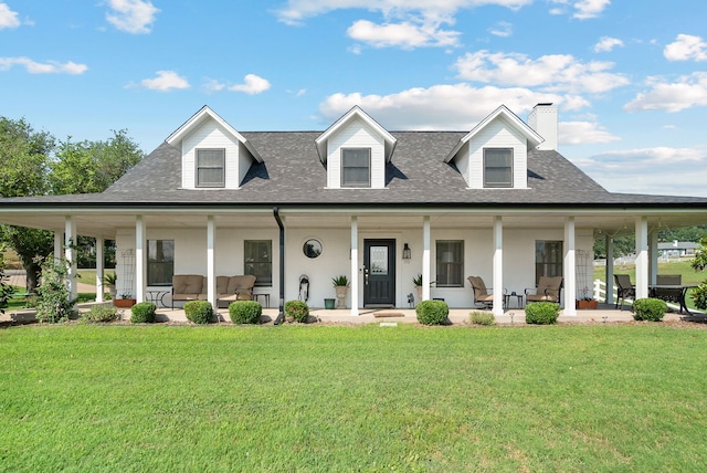 farmhouse inspired home with a front lawn and a porch