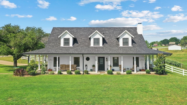 view of front of house with a front yard and an outdoor hangout area