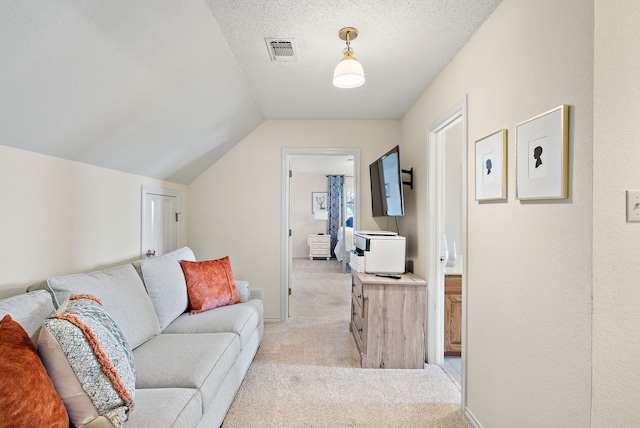 carpeted living room with a textured ceiling and lofted ceiling