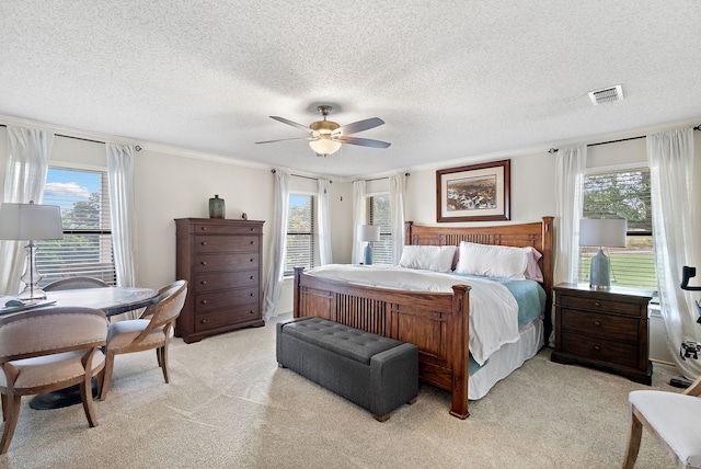 bedroom with multiple windows, ceiling fan, light carpet, and ornamental molding