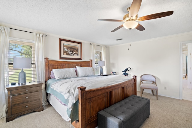 carpeted bedroom featuring multiple windows, a textured ceiling, ceiling fan, and crown molding