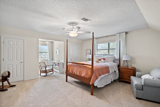 bedroom featuring ceiling fan, lofted ceiling, light carpet, and multiple windows