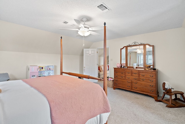 bedroom featuring a textured ceiling, ceiling fan, light colored carpet, and vaulted ceiling