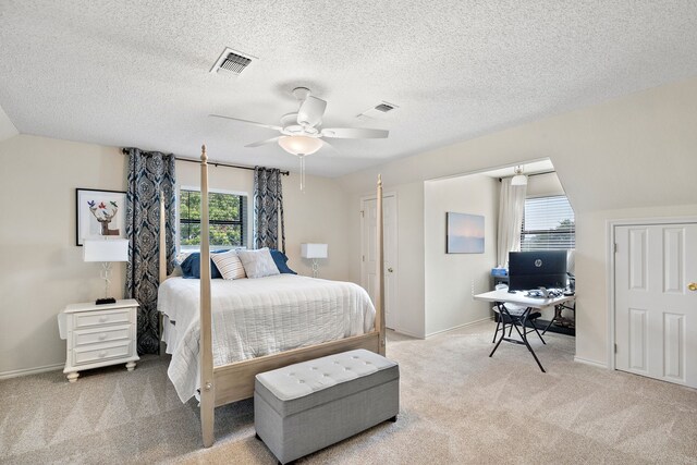 carpeted bedroom with ceiling fan, lofted ceiling, and a textured ceiling