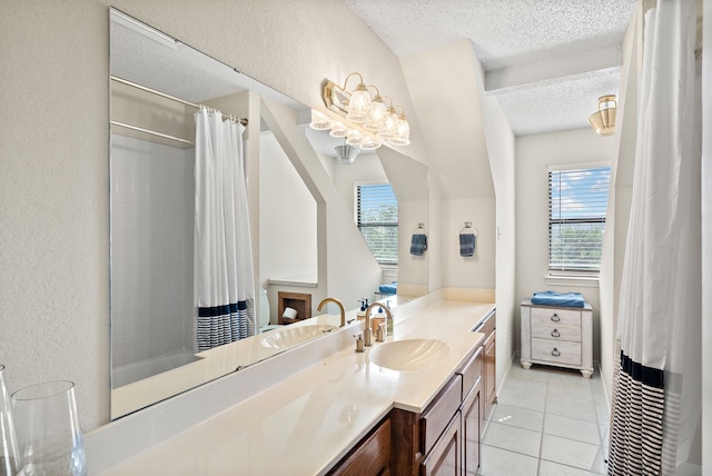 bathroom featuring tile patterned flooring, vanity, and a textured ceiling