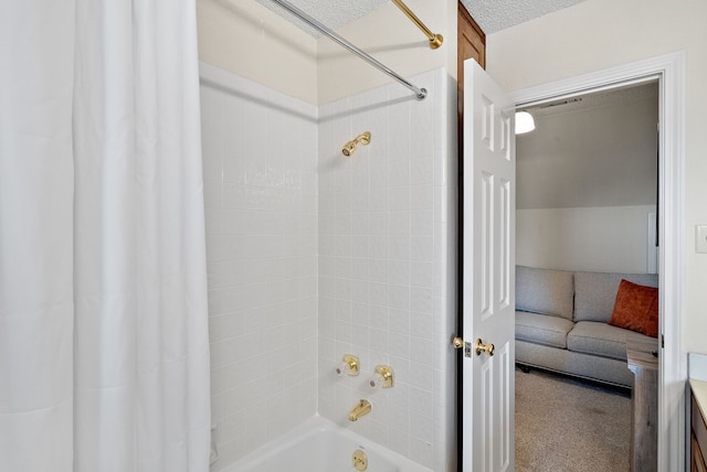 bathroom featuring shower / bathtub combination with curtain and a textured ceiling