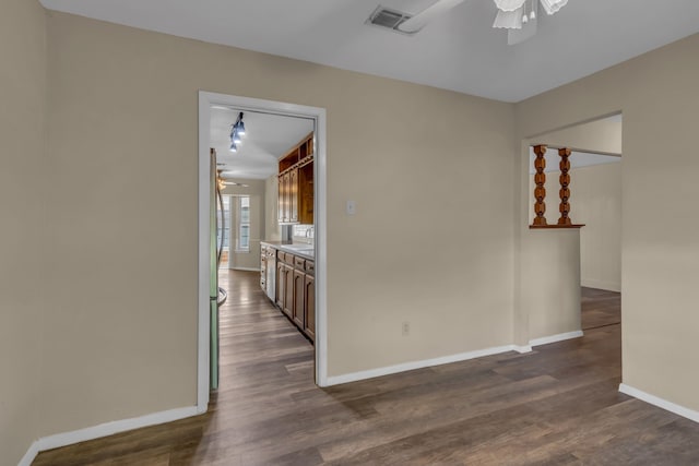 empty room with ceiling fan and dark wood-type flooring