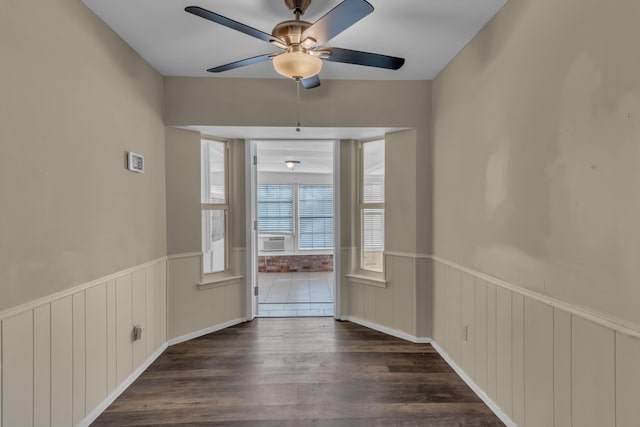 unfurnished room with ceiling fan, cooling unit, and dark hardwood / wood-style floors