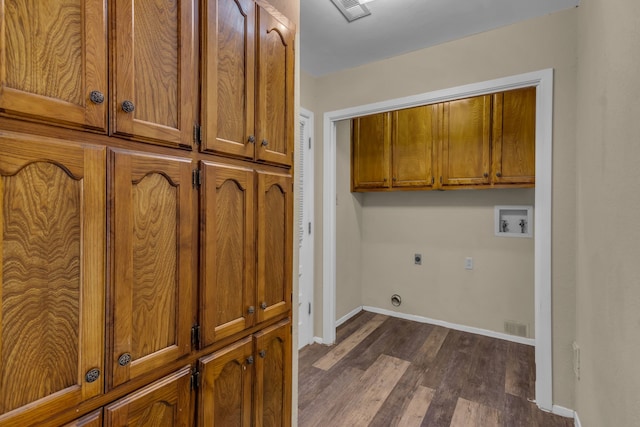 clothes washing area featuring cabinets, hookup for a washing machine, dark hardwood / wood-style floors, and electric dryer hookup