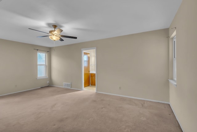 carpeted spare room with ceiling fan